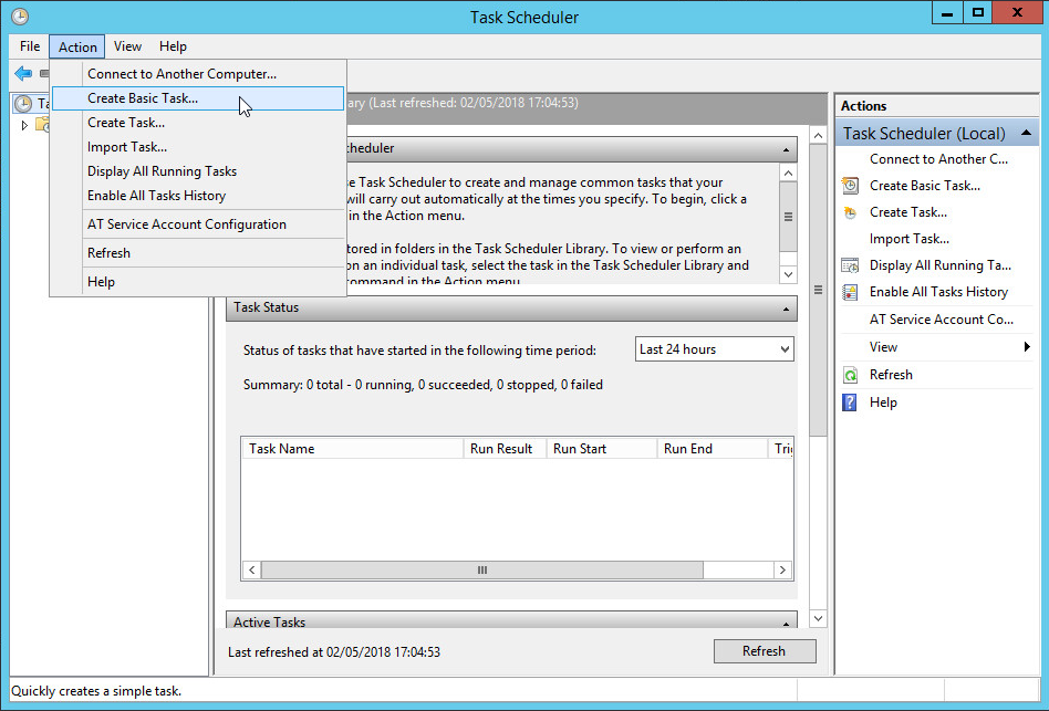 Task Scheduler screen showing a cursor selecting the Create Basic Task... item from the Action menu at the top of the screen